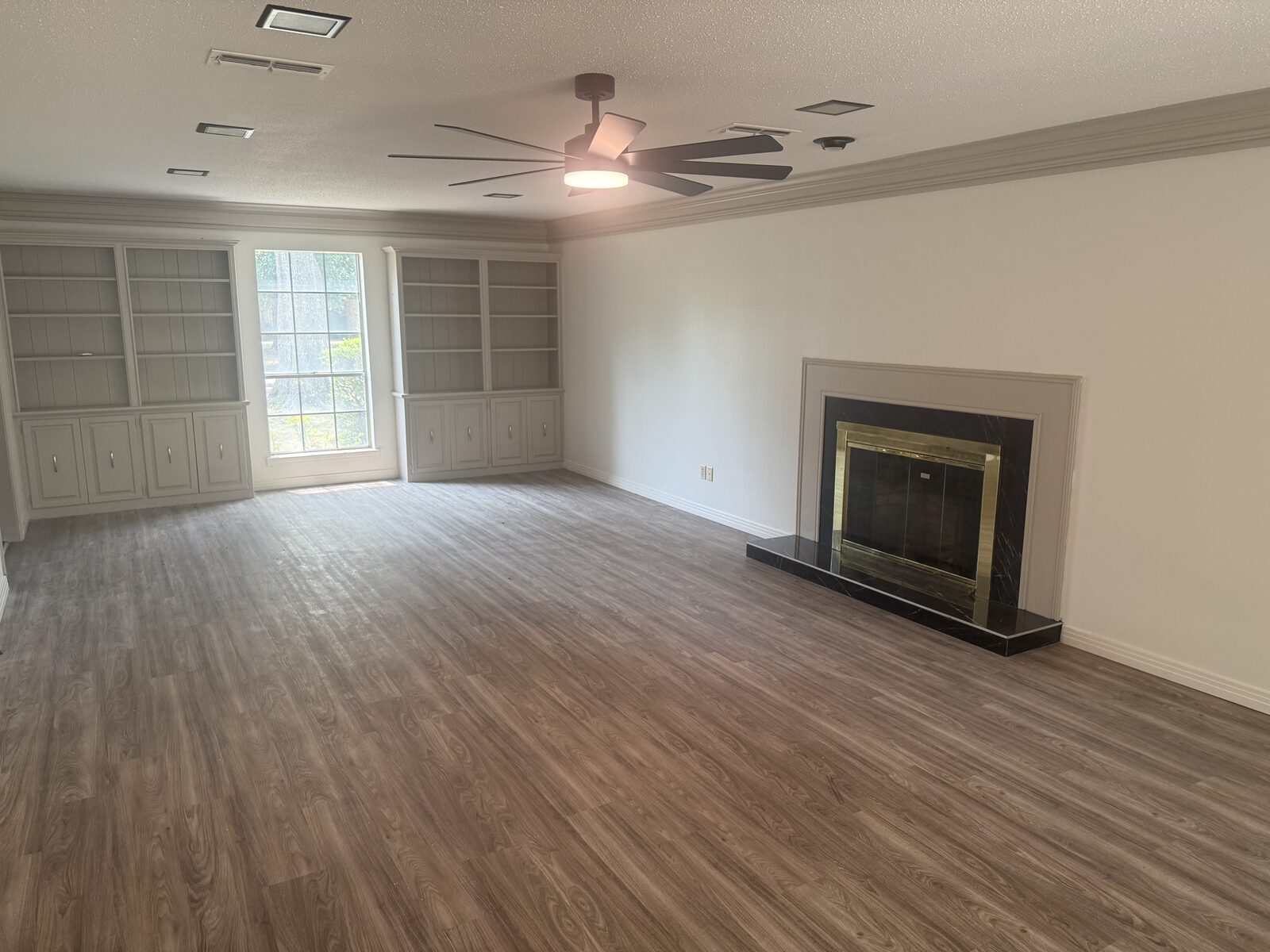 Living room with fireplace and built-in shelving