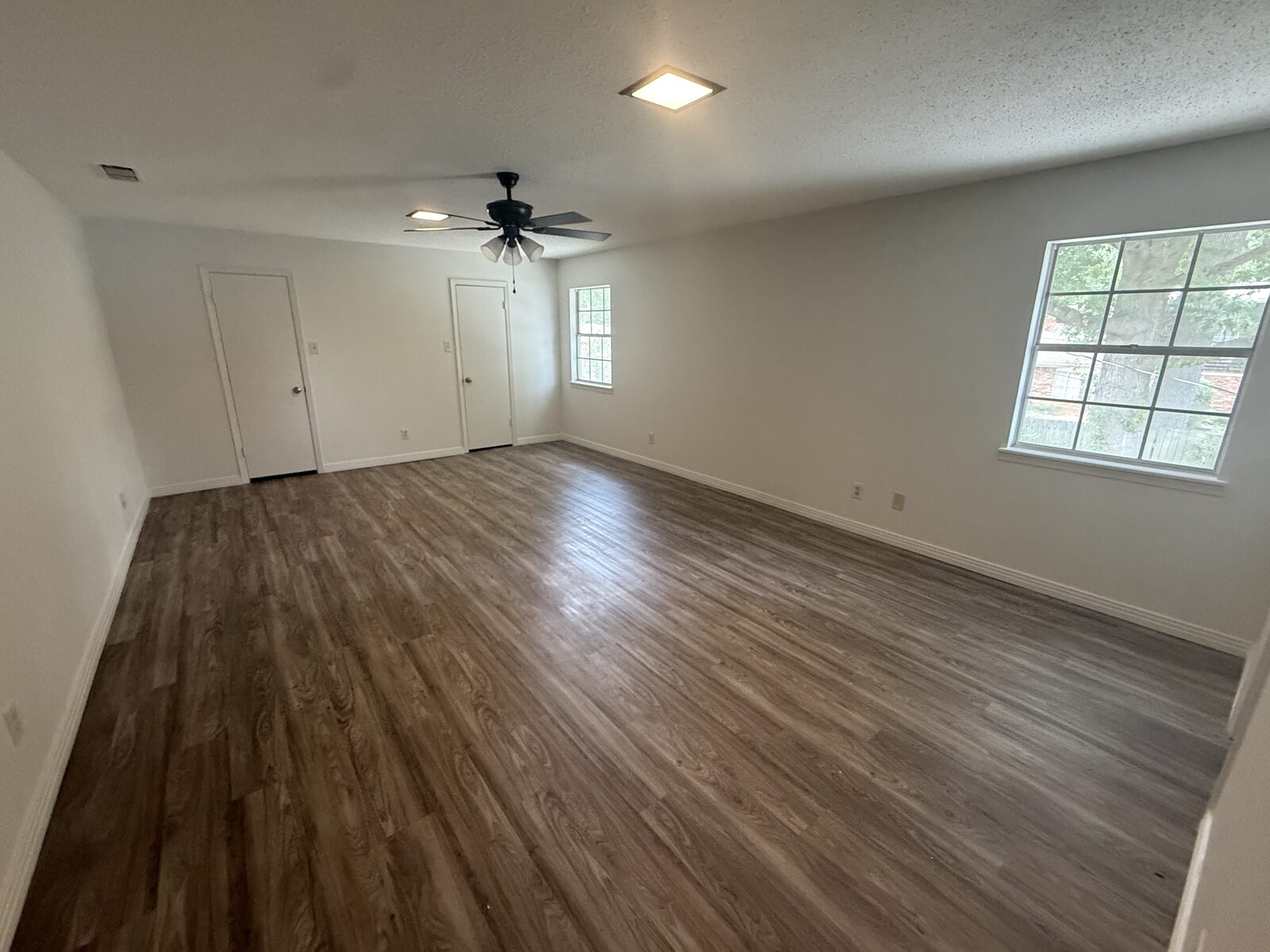 Spacious bedroom with ceiling fan