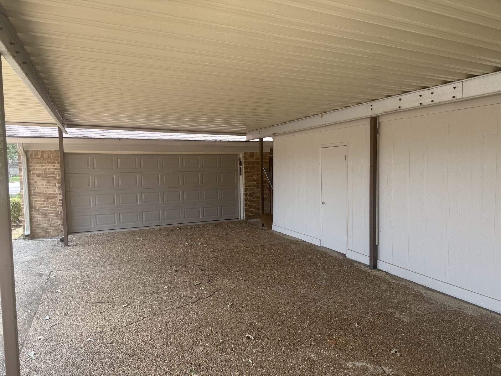 Covered carport with garage entry